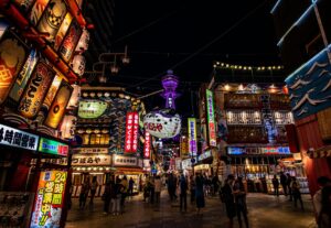 Osaka's Shinsekai district lit up at night near Tsutenkaku Tower, a popular nightlife and dining area